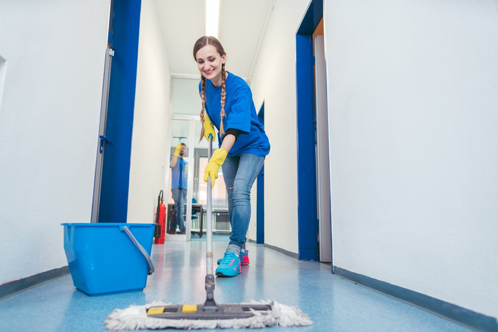 Cleaning Lady Mopping the Floor in an Office Building